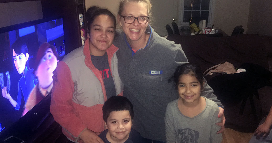 Rachels kids smiling in a home.